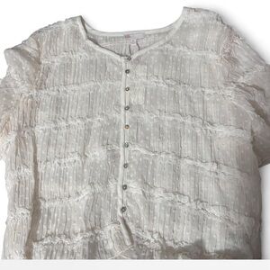 White sheer blouse with ruffles and button-up front.